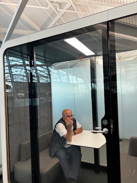 Deven in a modern meeting pod — always working for Ward 4