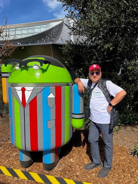 Deven with the Android mascot at Google campus — embracing technology